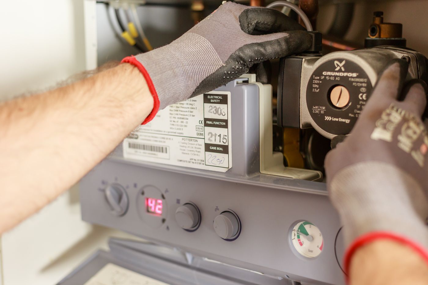 A technician servicing a water heater unit